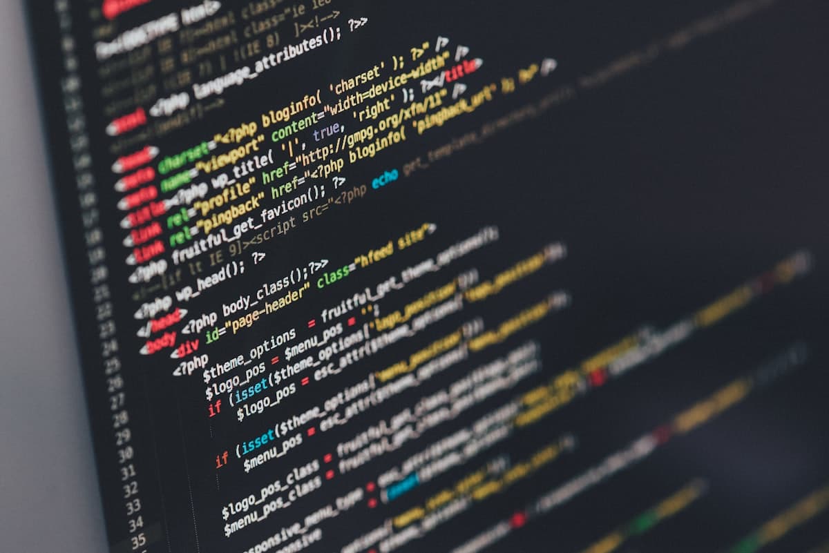 Source code on a monitor in a dark editor