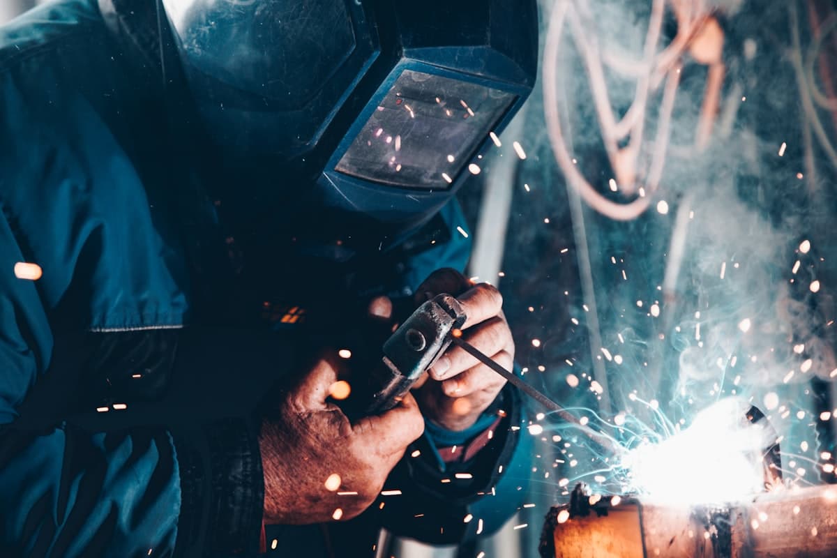 A welder at work under a shower of sparks